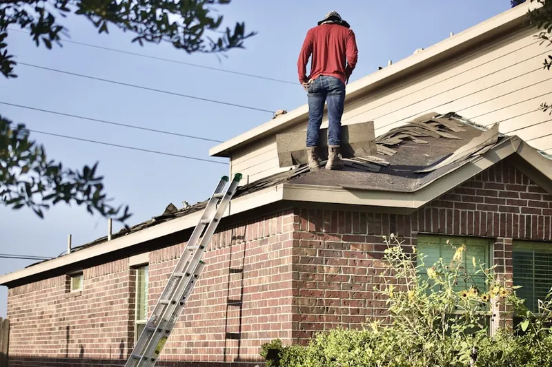 Professional roofer working on a residential roof in Hayt Corners